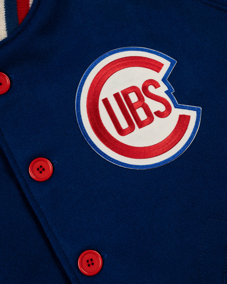 Close-up of the Chicago Cubs 1954 Authentic All Wool Varsity Jacket by EFF, featuring bright red buttons and a large circular Cubs logo patch in red and blue on white. Made in the USA as a replica of the classic 1950s team jacket.