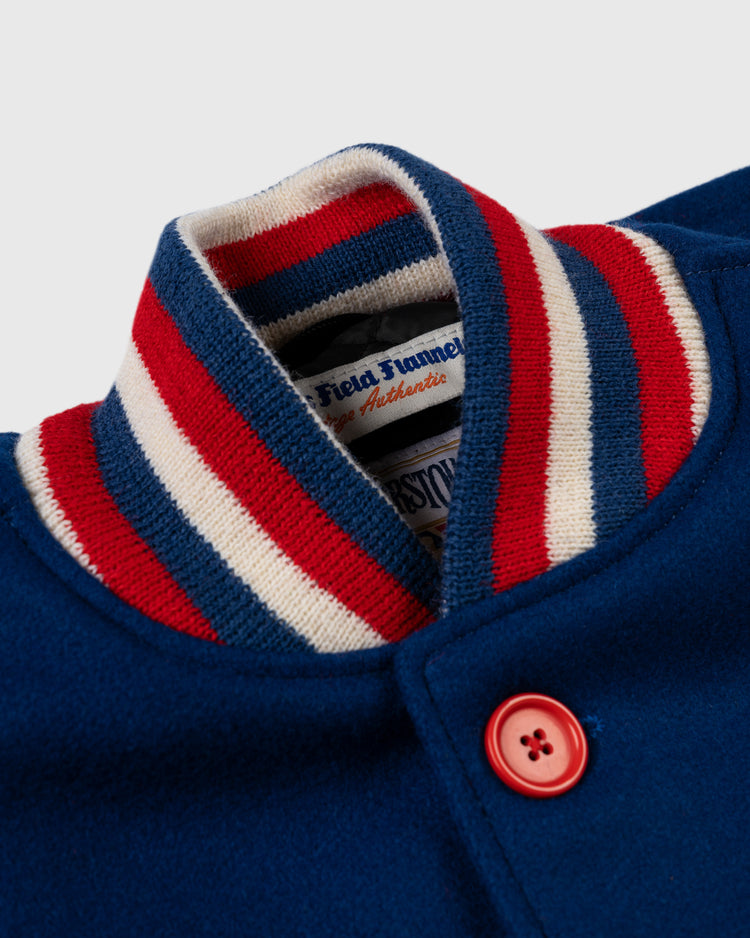 Close-up of the EFF Chicago Cubs 1954 Authentic All Wool Varsity Jacket, featuring a blue 1950s replica design with a red and white striped ribbed collar, red button, and classic Field Tunnel Authentics label—made in the USA.