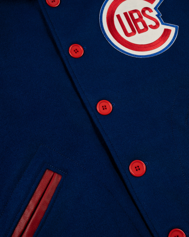 Close-up of the EFF Chicago Cubs 1954 Authentic All Wool Varsity Jacket, made in the USA, featuring red buttons, a striped pocket, and a Cubs logo patch on the chest.