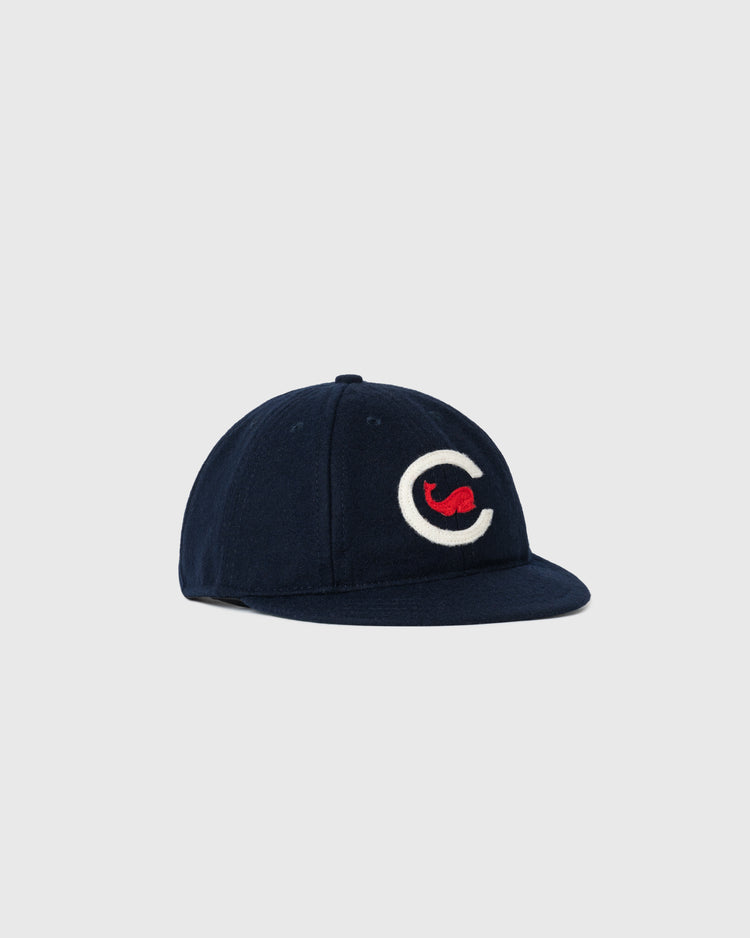A Chicago Whales 1915 Authentic 8-Panel Standard Brim Ballcap by Ebbets Field, navy blue with a curved brim, features a large white C with a red shape inside on the front. Shown against a plain light gray background.
