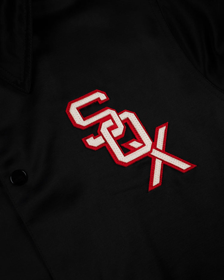 Close-up of the EFF Chicago White Sox 1959 Satin Windbreaker Jacket in black, showcasing the SOX logo in white with a red outline—ideal for vintage MLB fans.