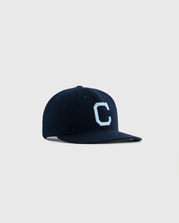 The EFF Columbia University 1960 Authentic Wool Ballcap is a navy blue cap featuring a light blue C logo, inspired by vintage Columbia ballcaps, shown on a plain light gray background.