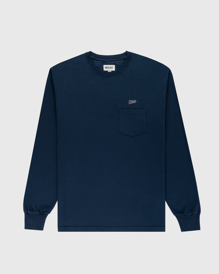 The Ebbets Field Flannels Ebbets Chest Logo Long Sleeve Pocket Tee is a navy blue cotton shirt with a left chest pocket and small logo, shown flat on a light gray background—a classic wardrobe staple.