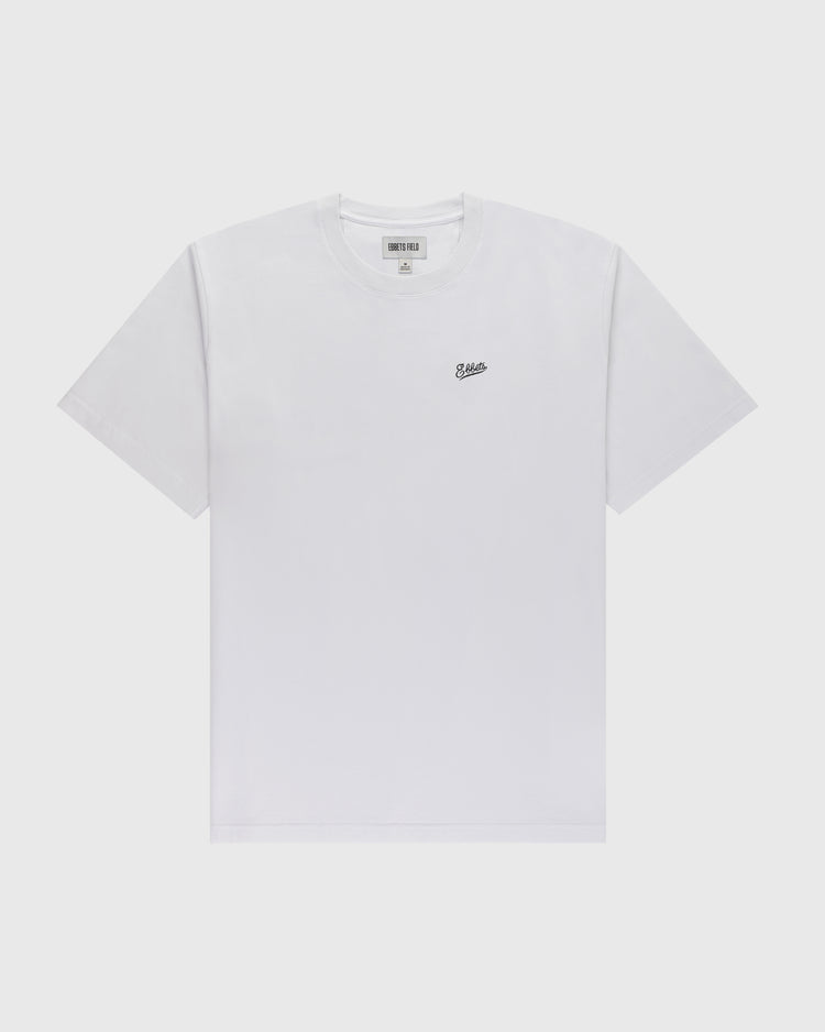 The Ebbets Chest Logo Short Sleeve Tee by Ebbets Field Flannels is a durable cotton white t-shirt featuring a small black embroidered chest logo, shown on a light gray background—a timeless wardrobe staple.