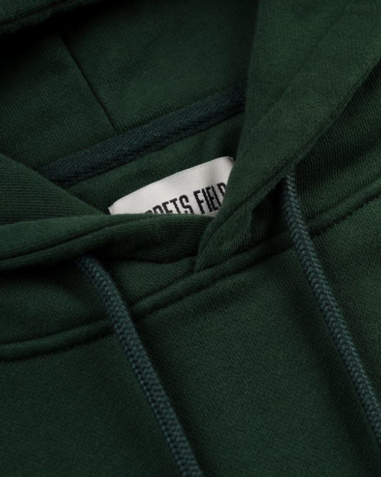 Close-up of the Ebbets Chest Logo Heavyweight Cotton Terry Pullover Hoodie by Ebbets Field Flannels in vintage-style dark green, showcasing a visible drawstring and a partially visible white ETS FIELD label inside the collar.