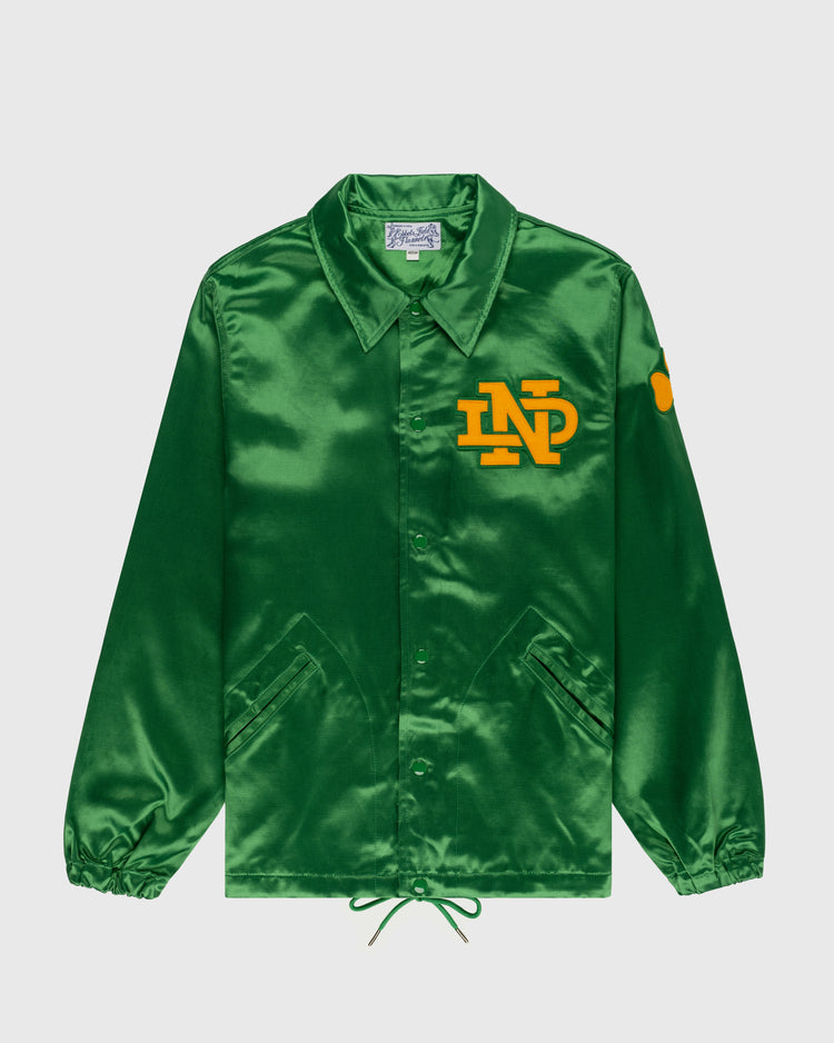 The EFF University of Notre Dame Satin Windbreaker Jacket is a shiny green satin jacket with a collar, yellow ND chest logo, yellow sleeve patch, front pockets, button closure, elastic cuffs, and drawstring hem.