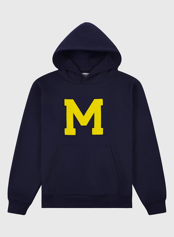 The Ebbets Field University of Michigan Heavyweight Cotton Terry Pullover Hoodie features a vintage navy design, bold yellow M on the front, and a kangaroo pocket. Displayed on a plain light background.