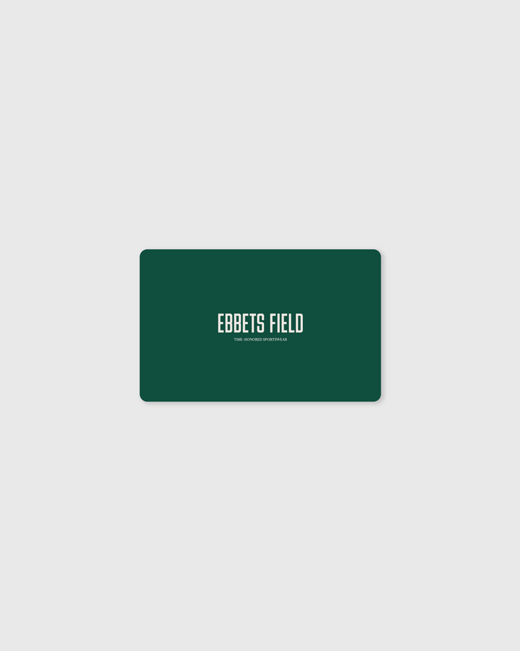 A green rectangular E-Gift Card from Ebbets Field with rounded corners displays “EBBETS FIELD” in white and “THE VINTAGE APPAREL CO.” below, centered on a light gray background—ideal for easy, stylish email gifting.