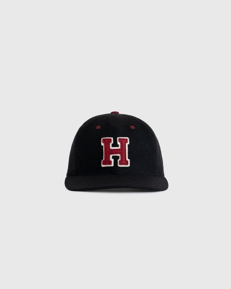 The EFF Harvard University Crimson H Authentic Wool Ballcap, a black cap with a bold red H and white outline on the front, is shown against a plain light gray background.