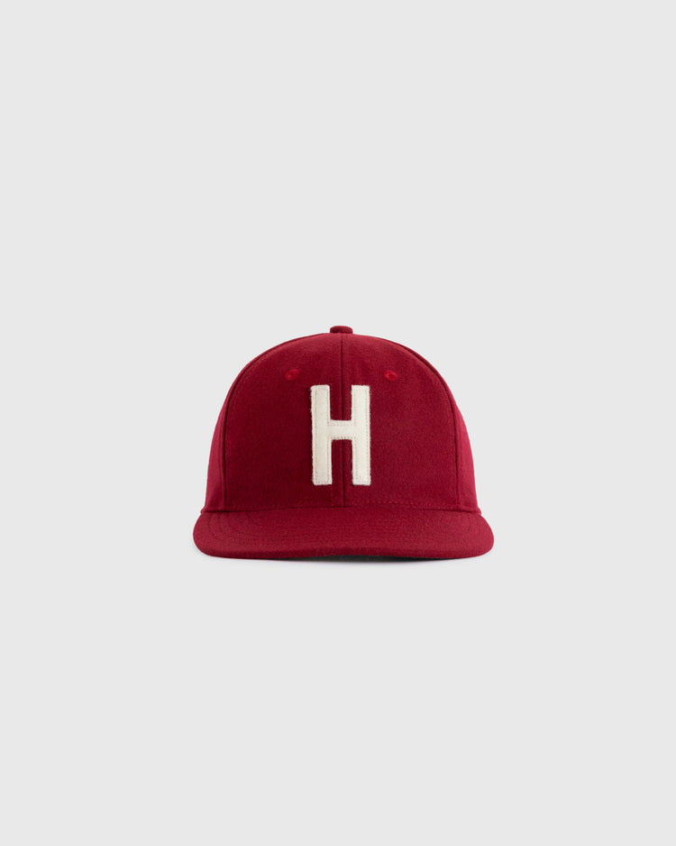 The EFF Harvard University 1950 Authentic Wool Ballcap, featuring a red design with a white H on the front, is an authentic reproduction shown against a plain light gray background.