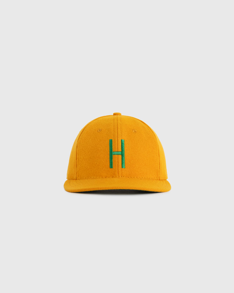 The EFF Hawaii Islanders 1961 Authentic Wool Ballcap is a yellow cap with a green H on the front, inspired by the original teams design, displayed against a plain light gray background.