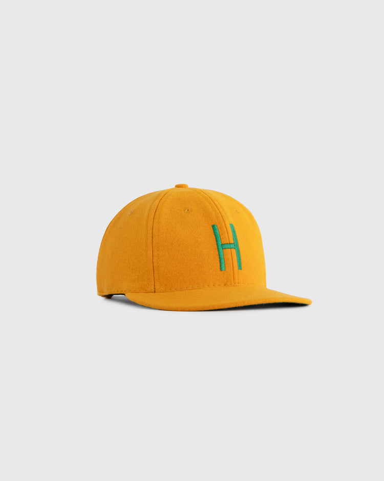 The EFF Hawaii Islanders 1961 Authentic Wool Ballcap features mustard yellow wool and a green embroidered H, shown against a plain light gray background.