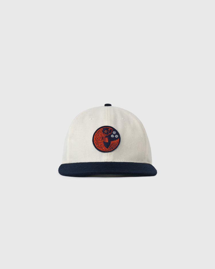The EFF Hiroshima Carp Off White Wool Ballcap features a dark navy brim and a front patch with a red and navy fish design. The background is plain, light gray.