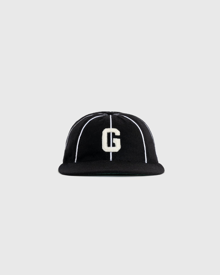 The EFF Homestead Grays 1939 Authentic Wool 8-Panel Ballcap features a black design with thin white stripes and a large white âGâ on the front, displayed against a plain gray background.