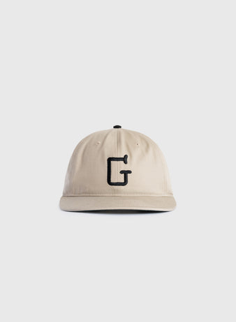 The Ebbets Field Flannels Homestead Grays Embroidered G Cotton Twill Ballcap, shown on a plain white background, features beige cotton twill and a black embroidered letter G in tribute to baseball history.
