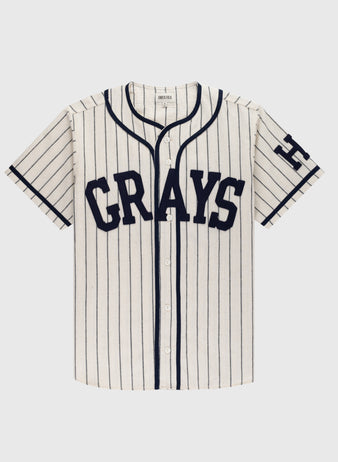 The Ebbets Field Flannels Homestead Grays 1939 Authentic Wool Home Baseball Jersey features cream wool, navy pinstripes, CRAYS on the front, and an H on the sleeve—faithfully replicating the legendary 1939 Grays look.
