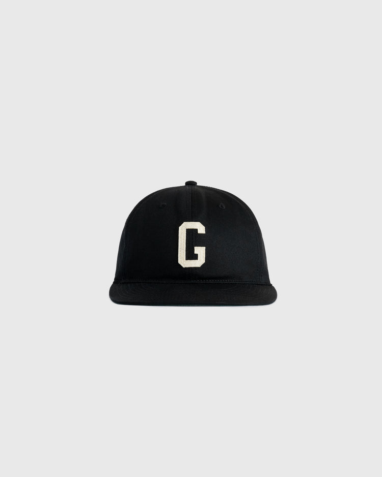 The Ebbets Field Flannels Homestead Grays Felt G Cotton Twill Ballcap features a black cotton twill build with a white felt G on the front, inspired by the classic Homestead Grays cap, shown on a plain light gray background.