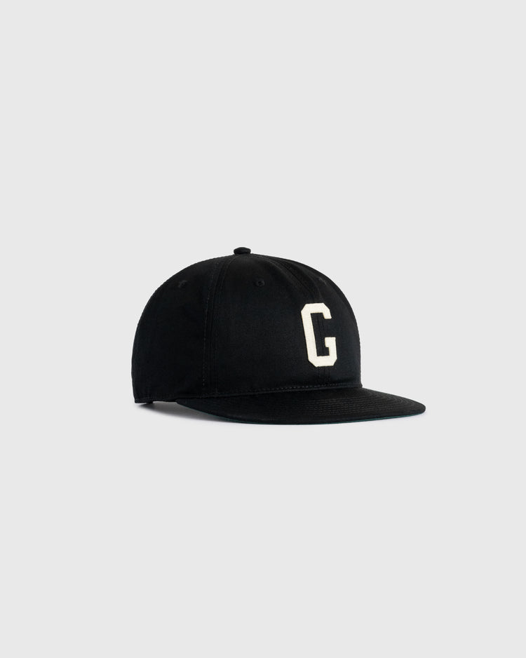 The Ebbets Field Flannels Homestead Grays Felt G Cotton Twill Ballcap features a black flat brim, white felt G on the front, and classic Negro Leagues styling, shown against a light gray background.