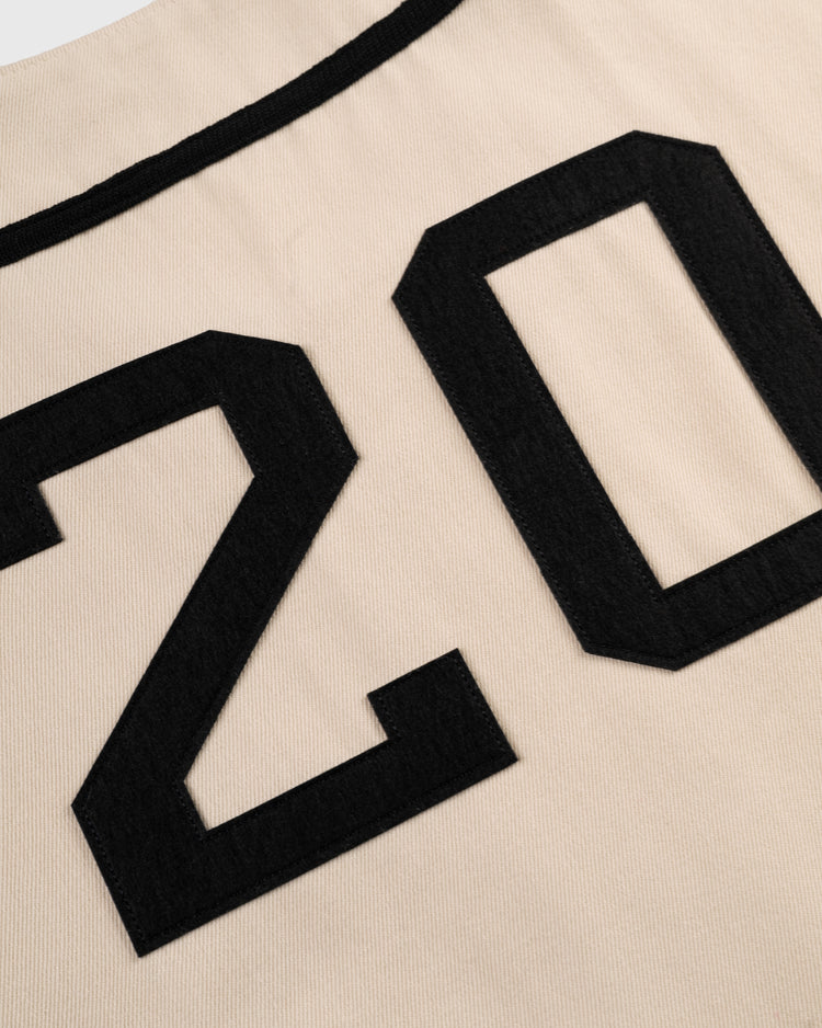 Close-up of beige cotton twill fabric with black “20” sewn on, part of the Ebbets Field Flannels Homestead Grays Baseball Jersey.