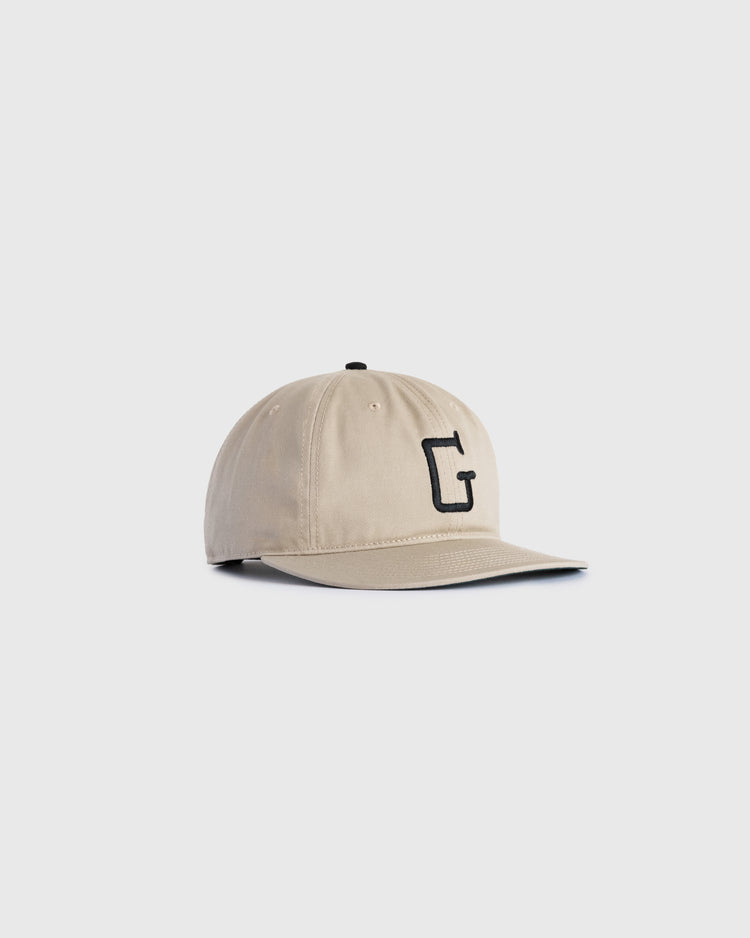 The Ebbets Field Flannels Homestead Grays Embroidered G Cotton Twill Ballcap features a beige cotton twill build and black G embroidery, honoring the Negro Leagues Baseball Museum. Shown on a plain white background.