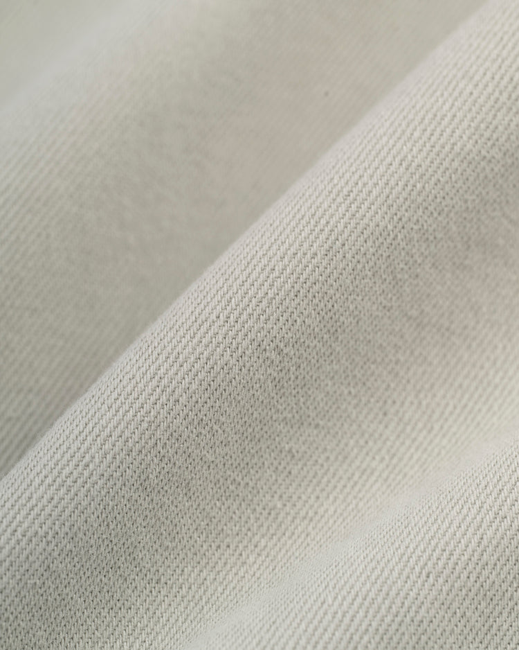 Close-up of the Ebbets Field Montreal Royals Cotton Twill Baseball Jersey, featuring light-colored, textured fabric with subtle diagonal lines and soft folds that reflect its classic cotton twill weave.
