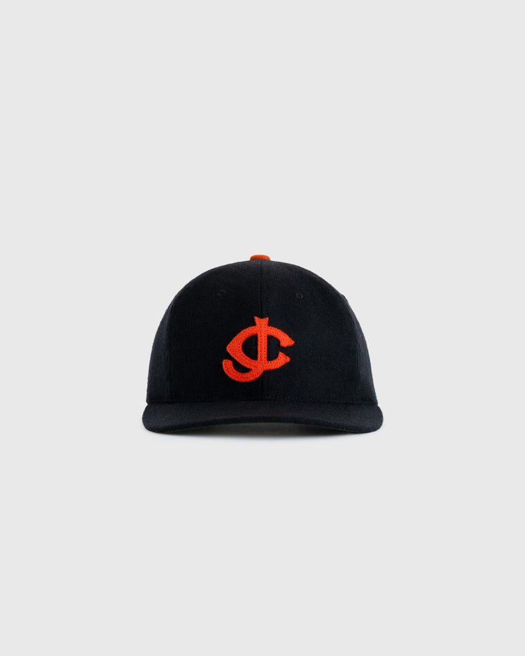 The EFF Jersey City Giants 1950 Authentic Wool Ballcap is black with an orange embroidered interlocking J and C logo, inspired by the historic team, and shown against a plain light gray background.
