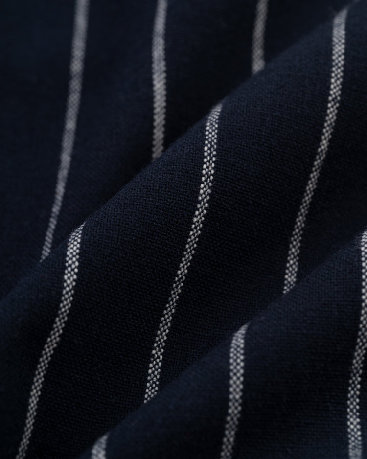 Close-up of Ebbets Fields Kansas City Monarchs 1924 Authentic Wool Road Baseball Jersey in navy blue, featuring thin white pinstripes and gentle folds, evoking the style of classic Negro Leagues uniforms.