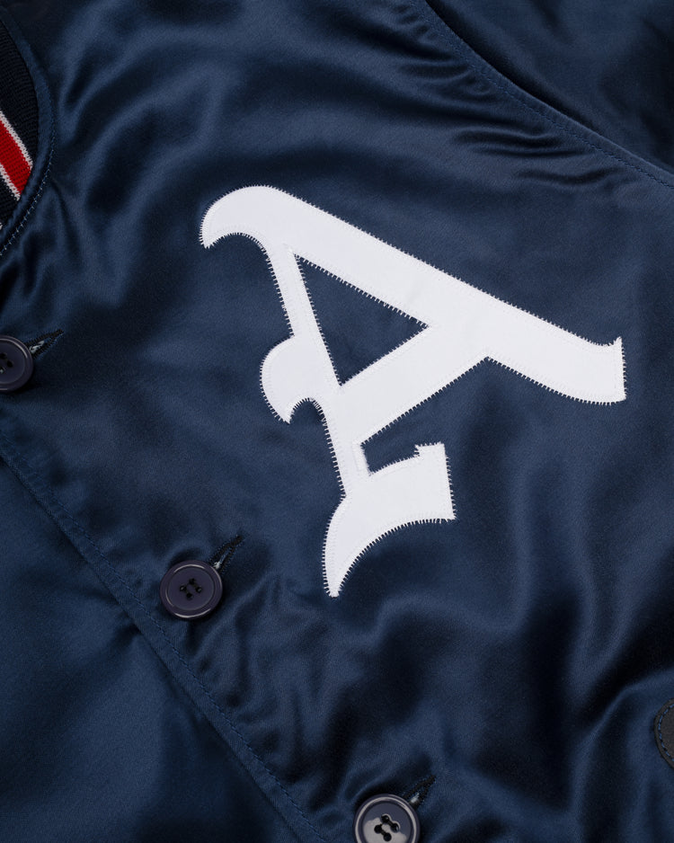 Close-up of the EFF Kansas City Athletics 1960 Authentic All Satin Varsity Jacket in navy, featuring a large white letter A appliqué and dark front buttons—a classic piece for vintage sportswear fans.