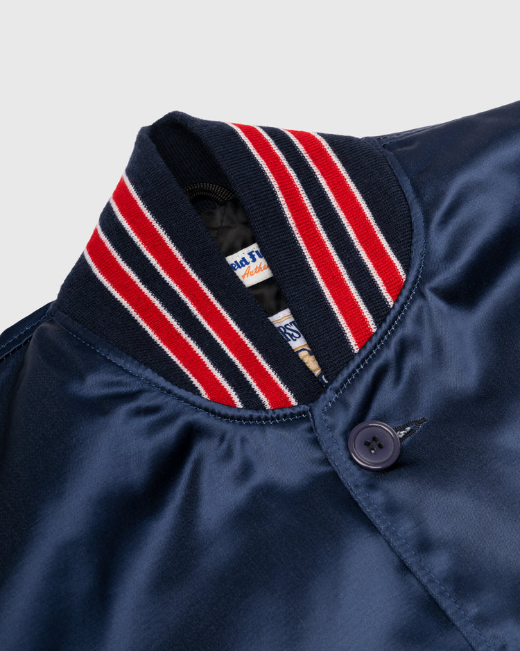 Close-up of the EFF Kansas City Athletics 1960 Authentic All Satin Varsity Jacket, featuring a ribbed red, white, and blue collar and a dark button near the neckline.