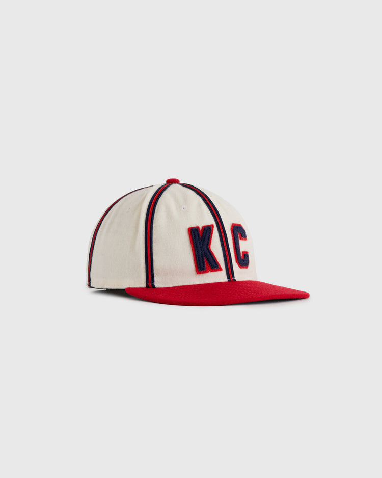 The EFF Kansas City Monarchs 1942 Authentic Wool Ballcap features a cream crown, red brim, large red and blue KC embroidery, navy pinstripes, and honors the legacy celebrated by the Negro Leagues Baseball Museum.