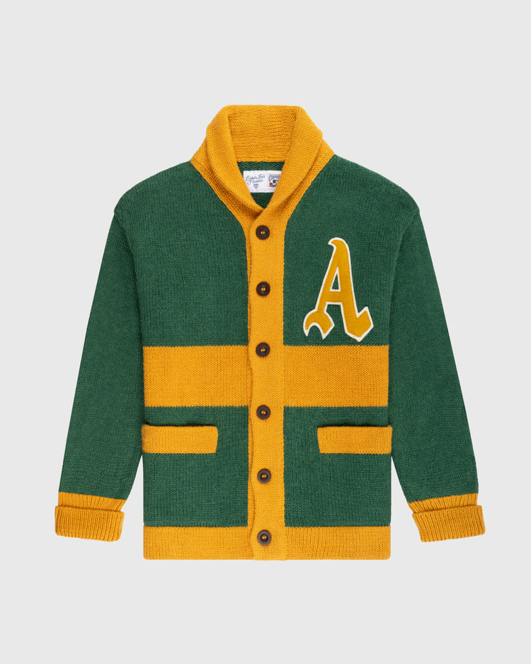 The Ebbets Field Flannels Oakland Athletics 1969 Wool Shawl Collar Sweater features green and yellow colors, brown buttons, two front pockets, yellow stripes, and a large yellow A patch on the left chest, shown on a white background.