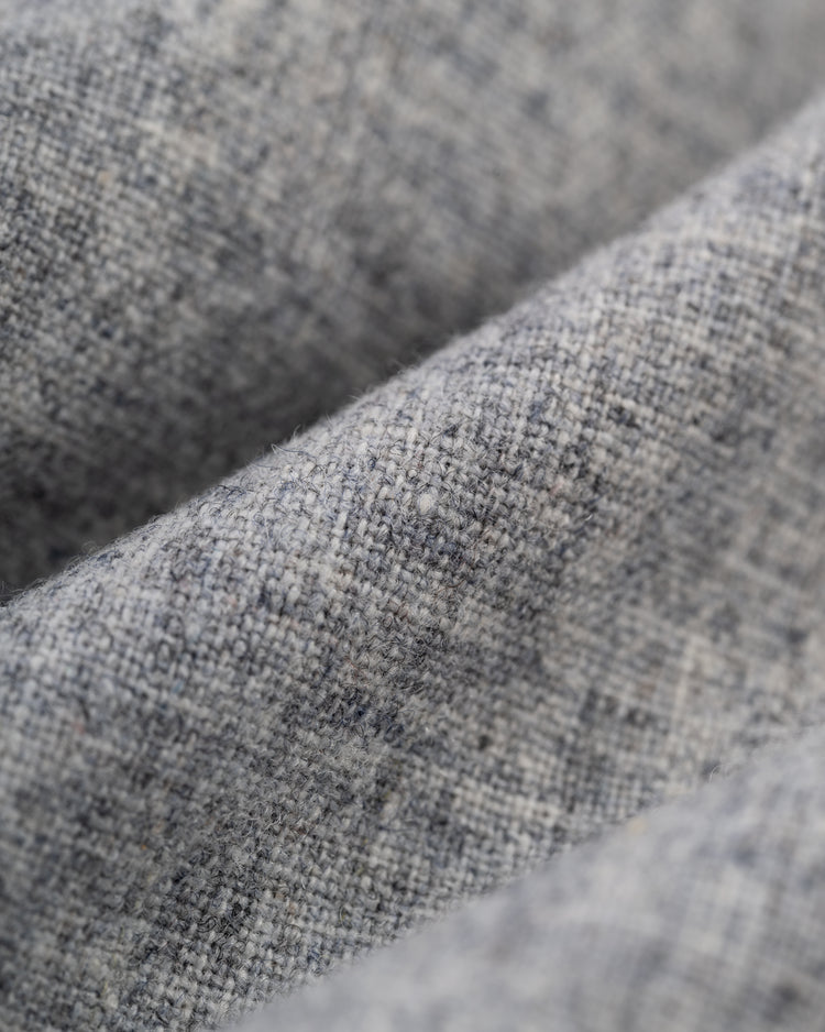 Close-up of light gray textured fabric with visible diagonal folds, as seen on the Montreal Royals 1946 Authentic Wool Road Baseball Jersey by Ebbets Field.