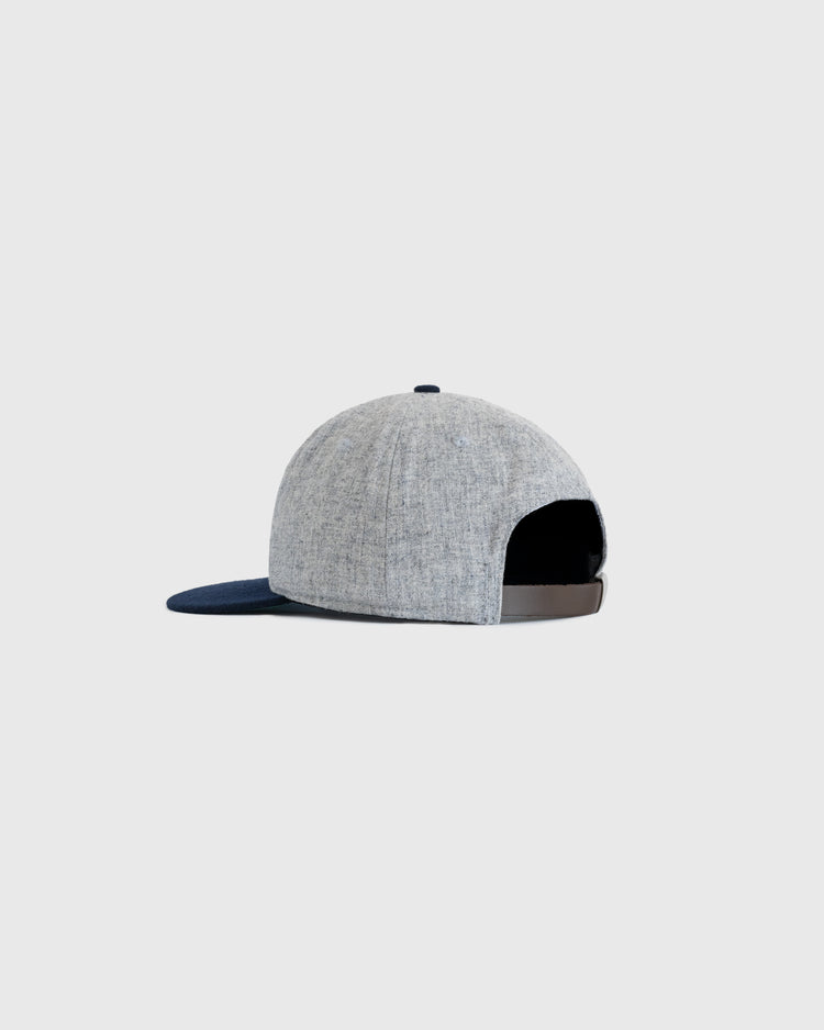 The EFF Navy 1947 Authentic Wool Ballcap features a light grey crown, dark blue brim, and adjustable strap, shown from the back against a plain light background.