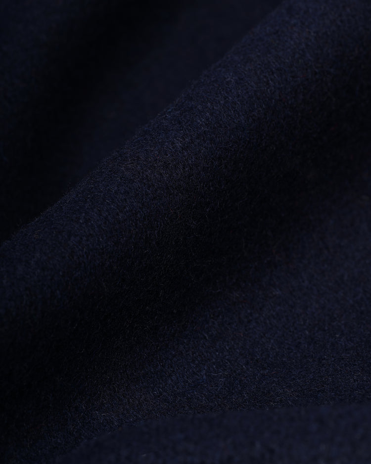 Close-up of soft, dark navy blue wool fabric from the EFF New York Yankees 1936 Authentic All Wool Varsity Jacket, featuring a slightly fuzzy texture and gentle folds that capture its classic look and feel.