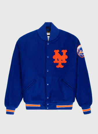 The EFF New York Mets 1969 Authentic All Wool Varsity Jacket in royal blue features orange and white striped cuffs and hem, a large orange NY logo on the chest, and a 1969 World Series team patch on the left sleeve.