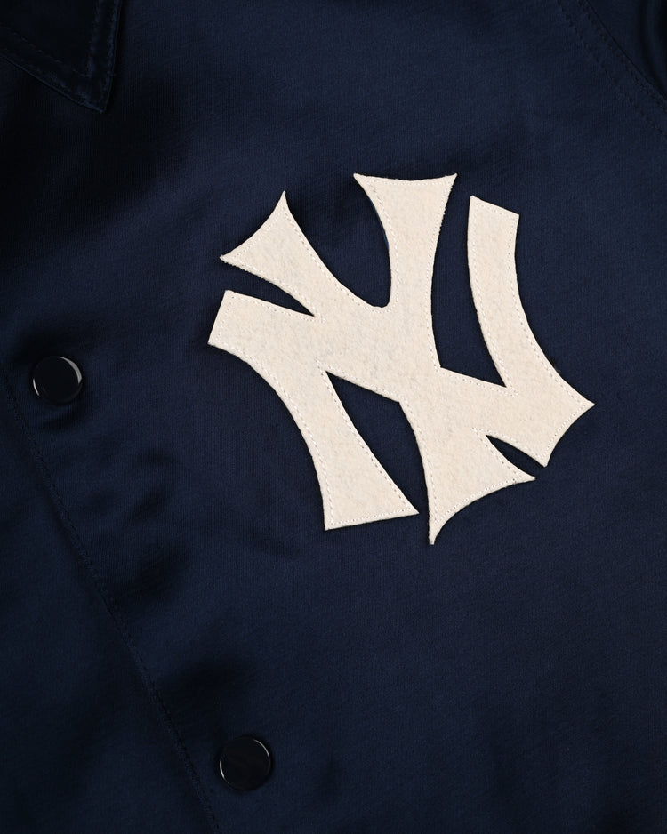 Close-up of the EFF New York Yankees 1946 Satin Windbreaker Jacket in navy blue, featuring a large white Yankees patch and two black buttons.