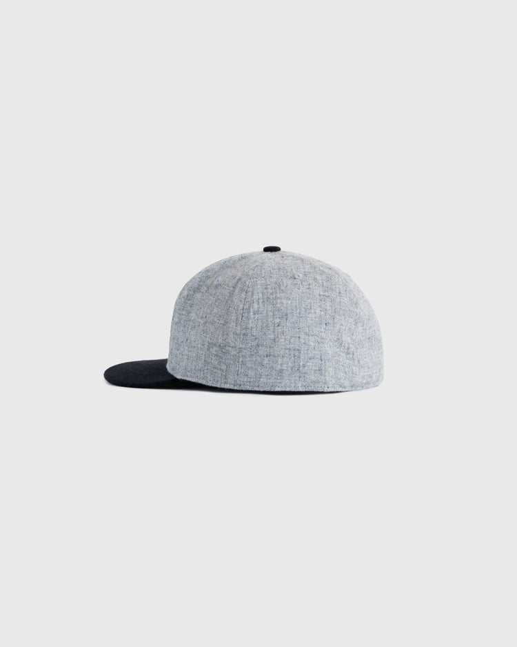 The EFF Osaka Tigers 1940 Authentic Wool Ballcap is shown from the side against a plain light background, featuring a gray crown, black brim, and detailed tiger patch—a standout piece of Japanese baseball memorabilia.