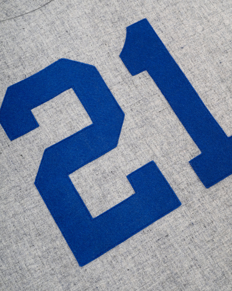 A close-up of the bold blue number 21 on light gray wool—an iconic detail from the Ebbets Field Puerto Rico 1958 National Team Authentic Road Baseball Jersey.