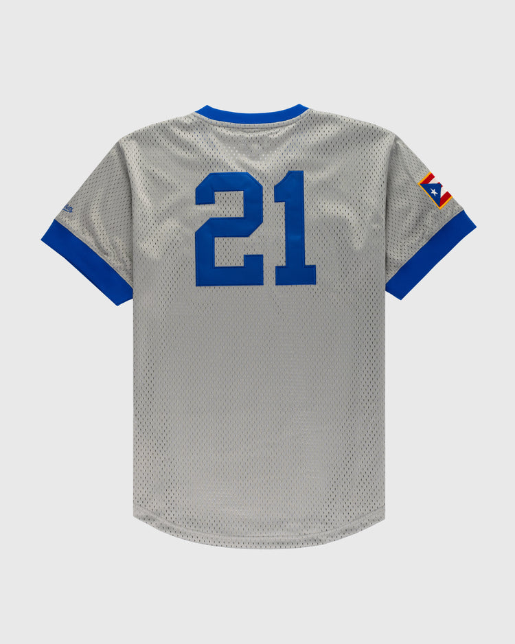 The Ebbets Field Puerto Rico 1958 National Team Mesh V-Neck Jersey is gray with blue sleeve cuffs and collar, a blue number 21 on the back, and a colorful Puerto Rico-inspired patch on the left sleeve.