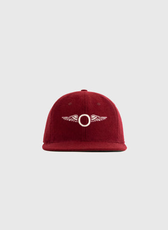The EFF San Francisco Olympics 1920 Authentic Wool Softbrim Ballcap in maroon features a white embroidered circle and wing design, shown on a light gray background—a true collector’s item for vintage sports fans.