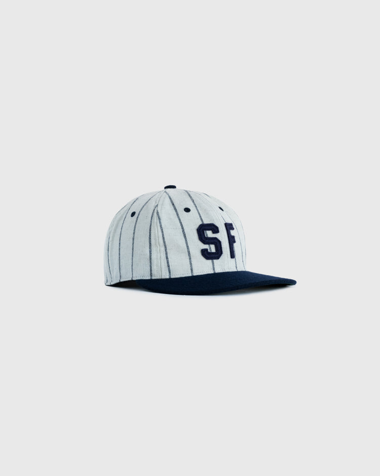 The EFF San Francisco Seals 1946 Authentic Wool Ballcap features gray wool with thin black stripes, a navy brim, and a navy 1946 SF logo on the front, shown against a plain light gray background.