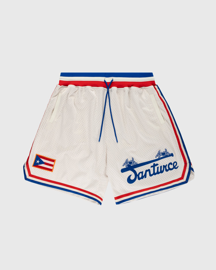 The Ebbets Field Santurce Cangrejeros Mesh Shorts feature white mesh fabric, red and blue trim, a blue drawstring, and the Puerto Rican flag on the left leg, inspired by baseball legend Roberto Clemente.