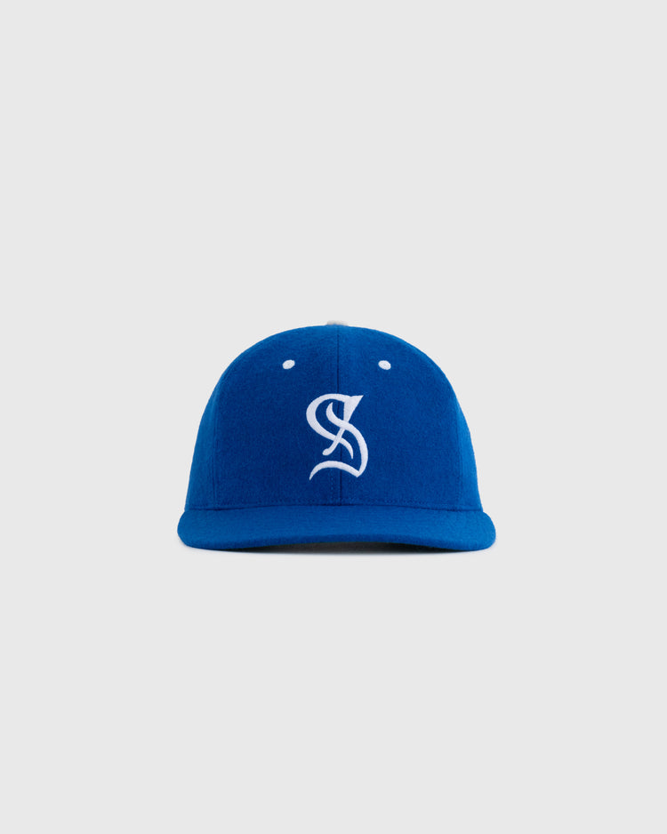 The EFF Santurce Cangrejeros 1954 Authentic Wool Ballcap features a bright blue color and a white embroidered stylized S logo, inspired by the iconic 1954 cap, shown against a plain light grey background.