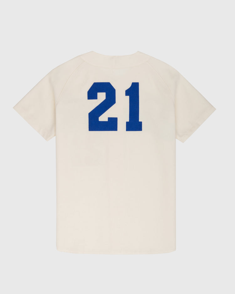 The Ebbets Field Santurce Cangrejeros 1954 Authentic Wool Home Baseball Jersey is cream-colored, short-sleeved, and inspired by the team’s home jersey, with the number 21 in large blue print on the back. It is displayed flat on a white background.
