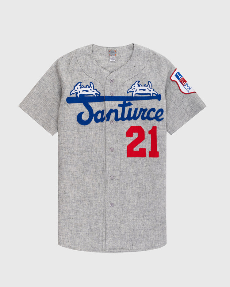 The Ebbets Field Santurce Cangrejeros 1954 Authentic Wool Road Baseball Jersey features Santurce in blue script, two white crabs, a blue bat, red 21 on the front, and a left sleeve patch—honoring Roberto Clemente.