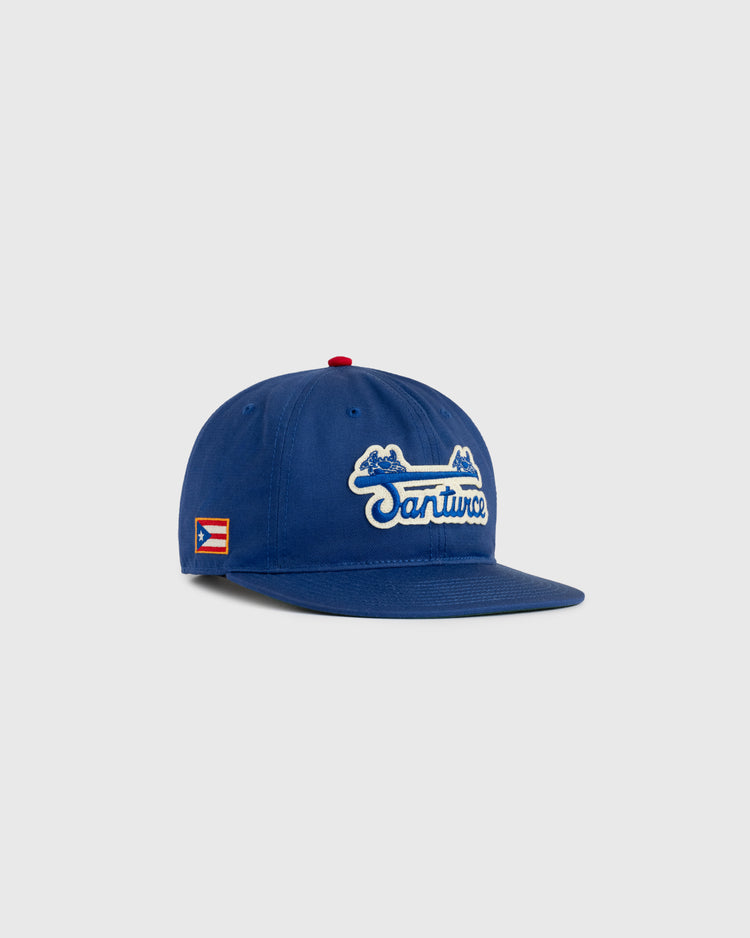 The Ebbets Field Santurce Cangrejeros Cotton Twill Ballcap features blue cotton twill and white lettering—ideal for fans of Puerto Rican baseball.