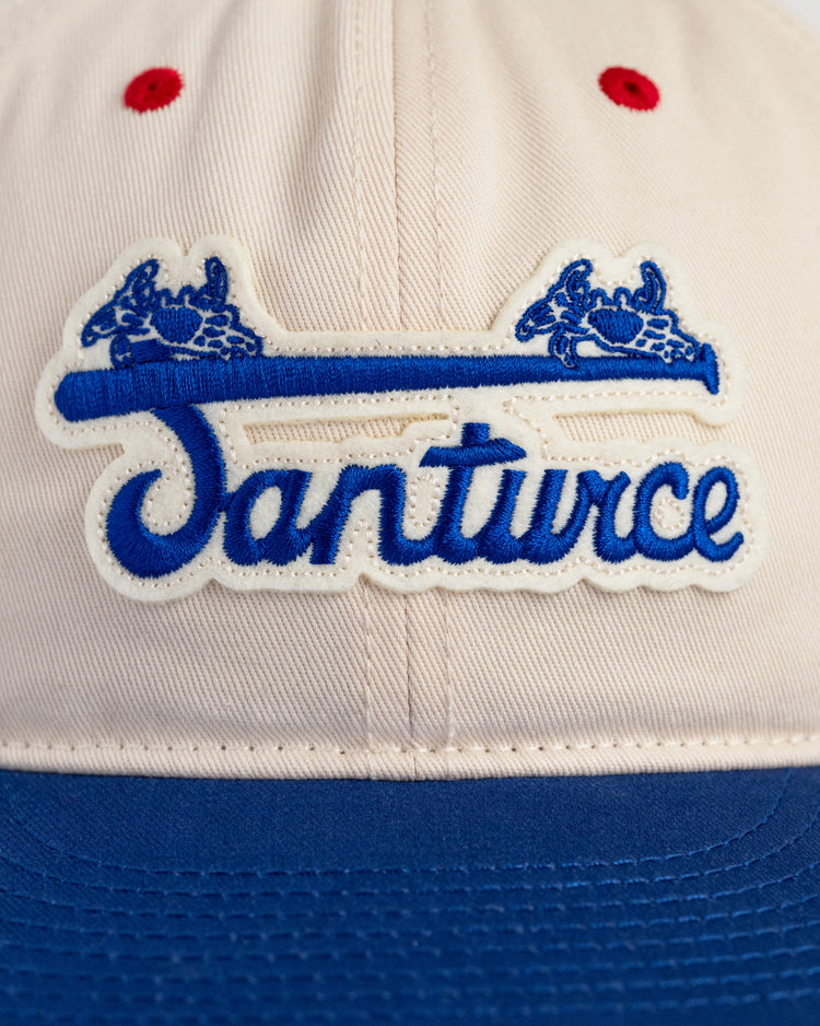 The Ebbets Field Santurce Cangrejeros Cotton Twill Ballcap features Santurce in blue script, two blue crabs, red accents, and honors Roberto Clemente’s Puerto Rican baseball legacy.