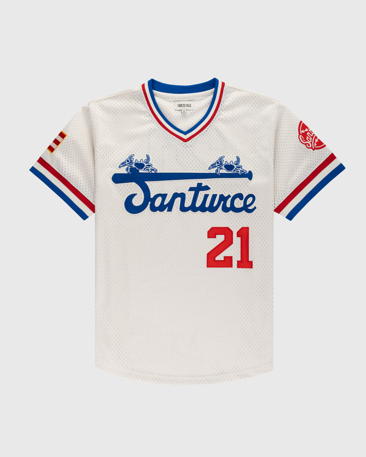 The Ebbets Field Santurce Cangrejeros Mesh V-Neck Jersey features blue script, red number 21, blue/red sleeve trim, flag and red logo patches—honoring Roberto Clemente and Puerto Rican baseball heritage.