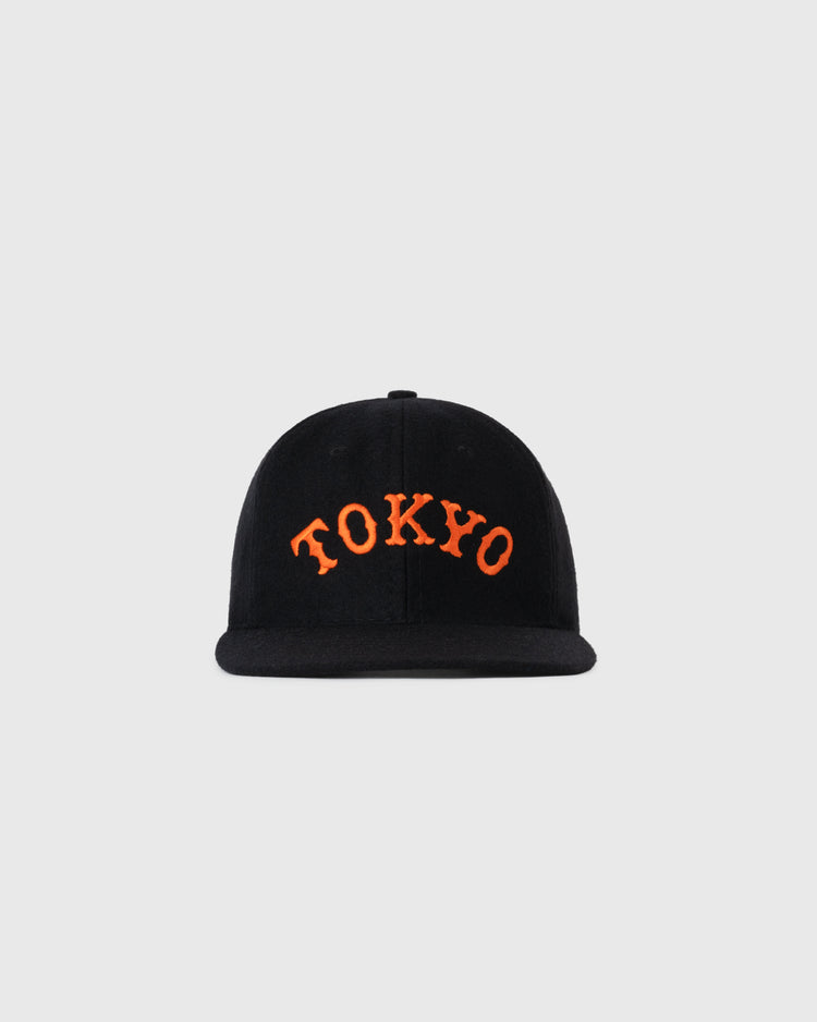 The EFF Tokyo Kyojin (Giants) City Series Wool Ballcap is a black cap with bold, curved orange TOKYO lettering on the front, shown against a plain light gray background.