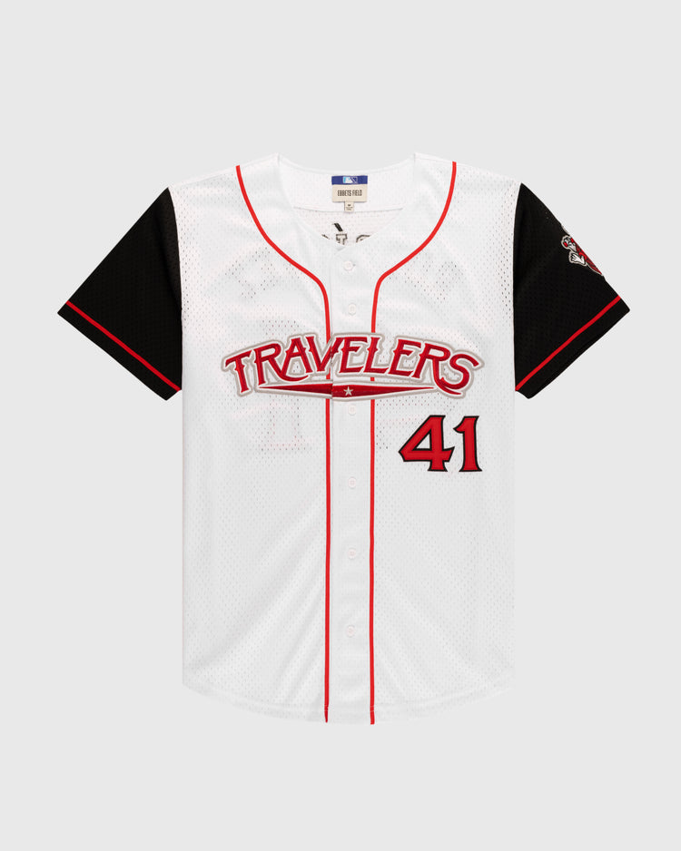 The Ebbets Field JULIO RODRIGUEZ BUTTON UP MESH JERSEY WHT/BLK is a white jersey with black sleeves and red trim, featuring Travelers in red across the chest and the number 41 in red on the lower right front.